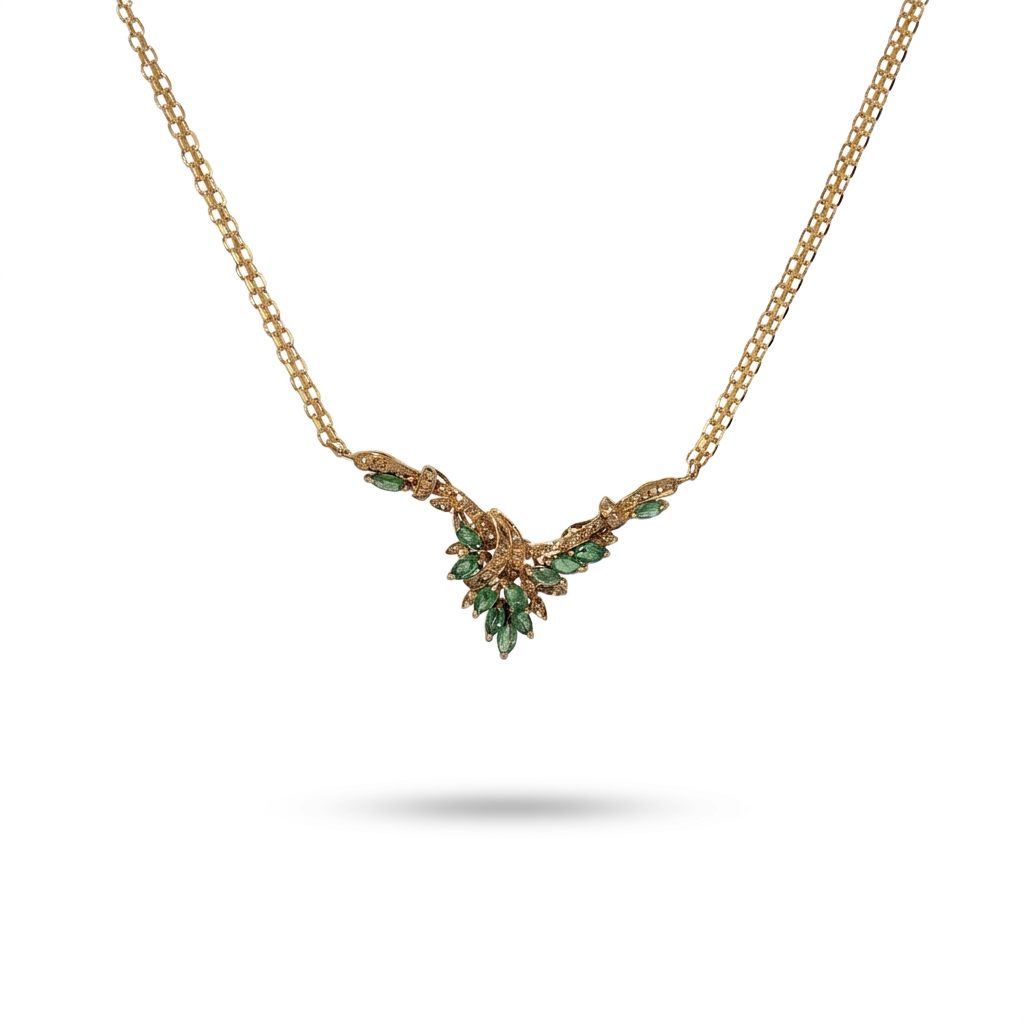 Female Necklace, 14K Yellow Gold featuring marquise-cut Emeralds (1.2ct, Eye Clean) and round Diamonds (0.15ct, G SI1) in a leaf motif.