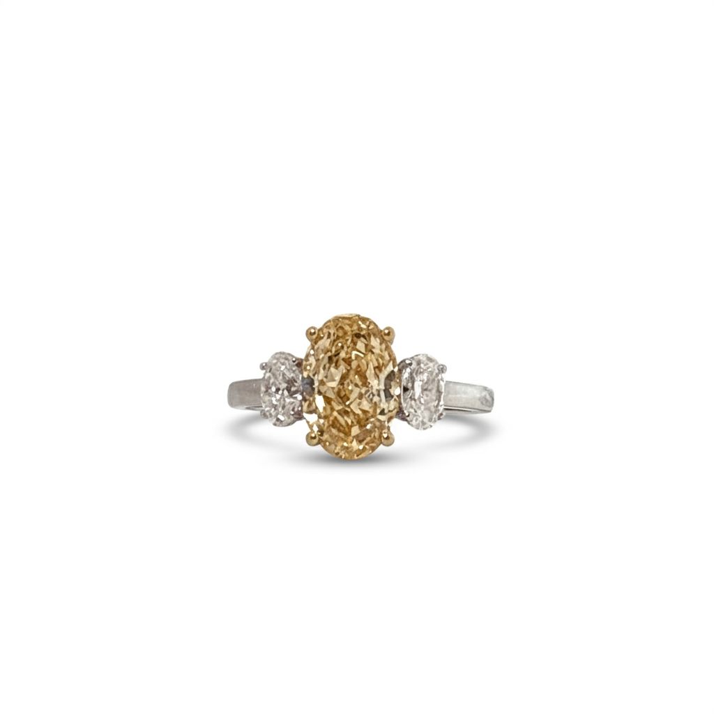 18K Dual White/Yellow Gold Ring, set with 1 Oval Fancy Intense Yellow Lab Grown Diamond (2.51ct, VS1) and 2 Oval D Colorless Lab Grown Diamonds (0.64ct total, VVS1), 3.1g.