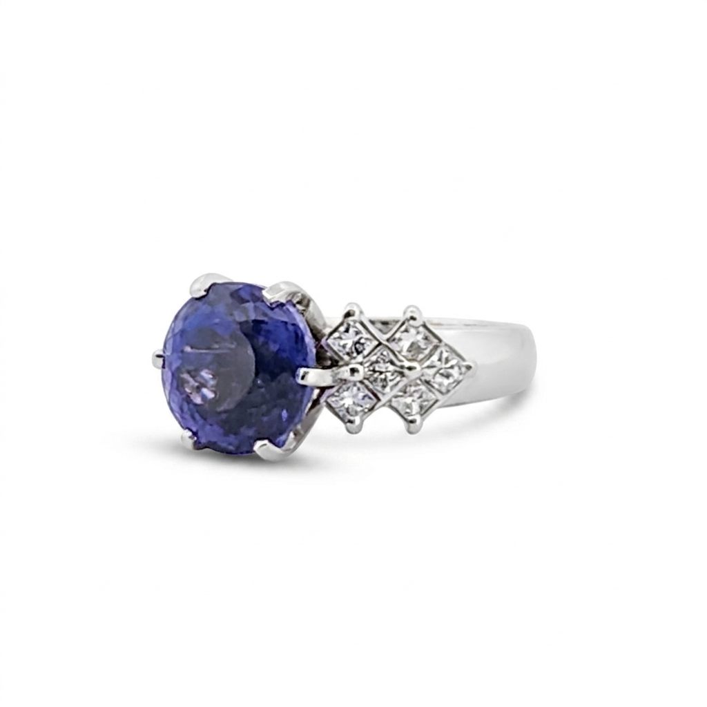 Natural Round Modified Brilliant Cut, Bluish Violet Tanzanite (5.25 CT - 10.20 mm) with 12 Natural Princess cut 3x3 mm Square Diamonds (1.92 CTW) Ring 14K White Gold. GIA Certified (2231466864).